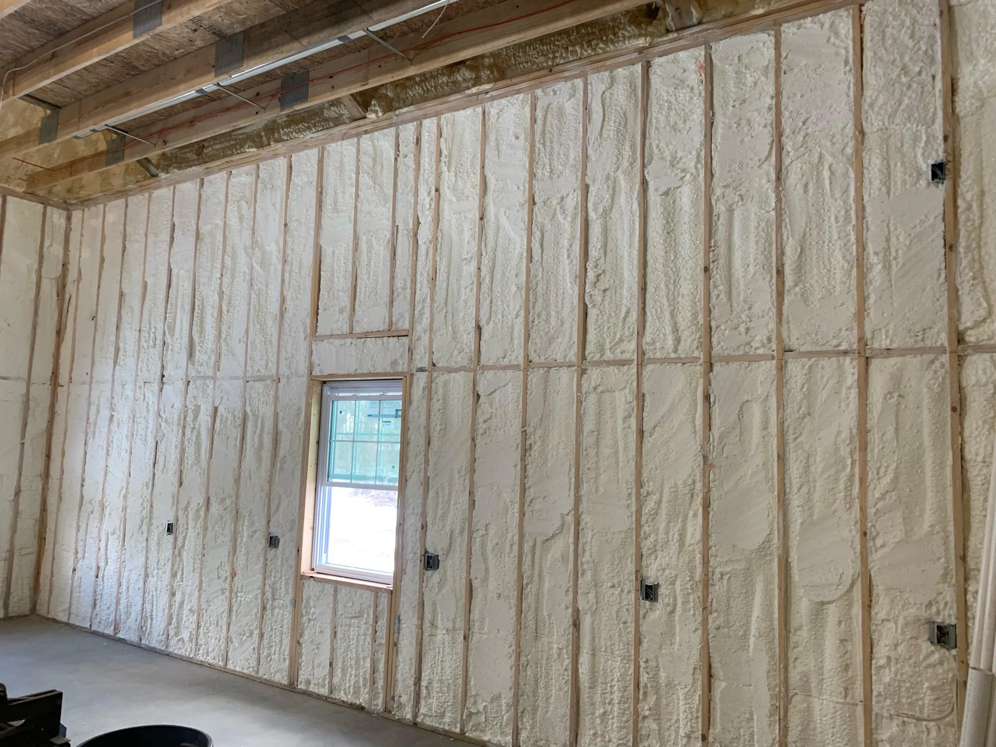 Spray foam insulation applied inside a framed building