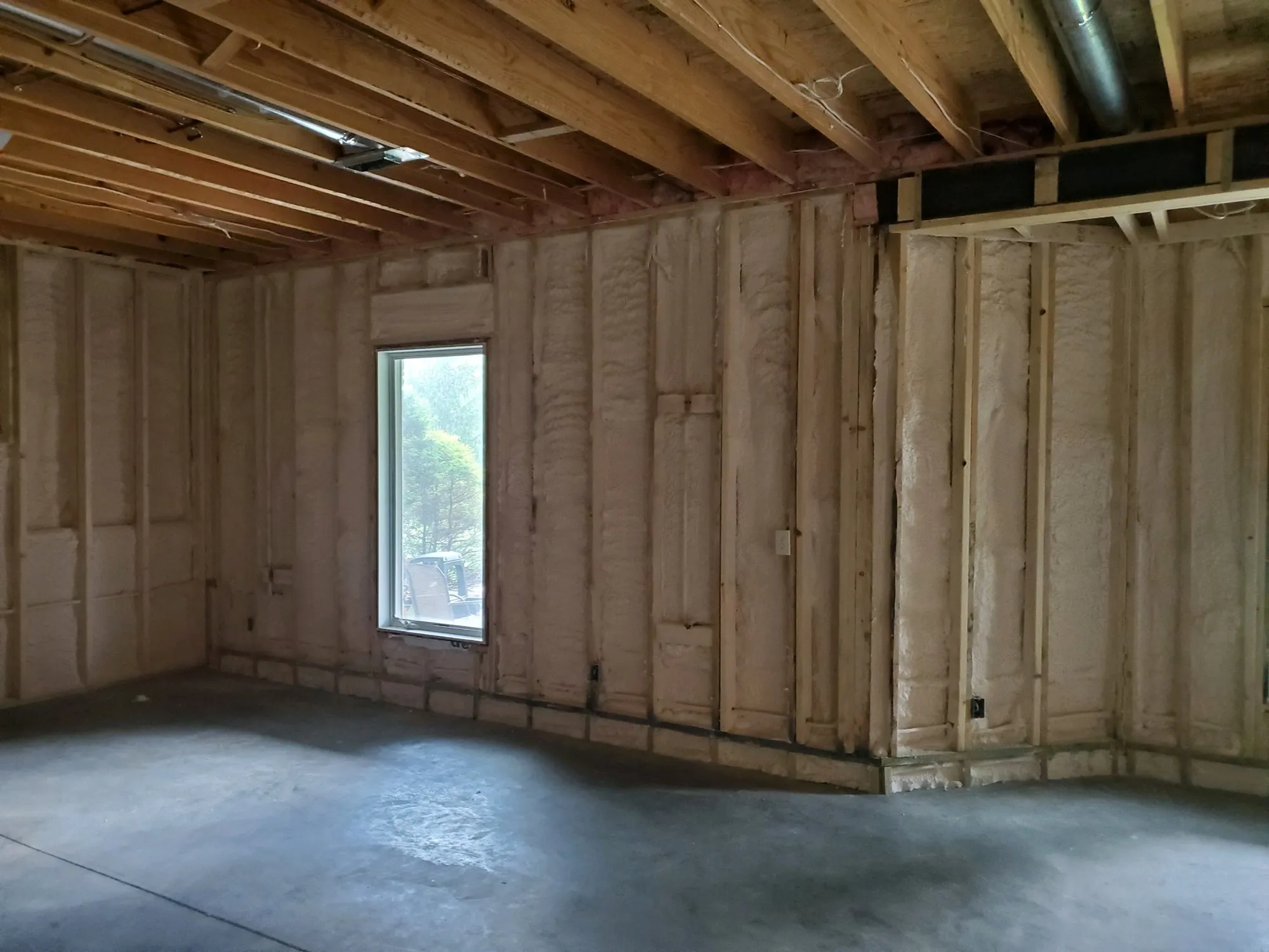 Attic insulation installed between roof framing