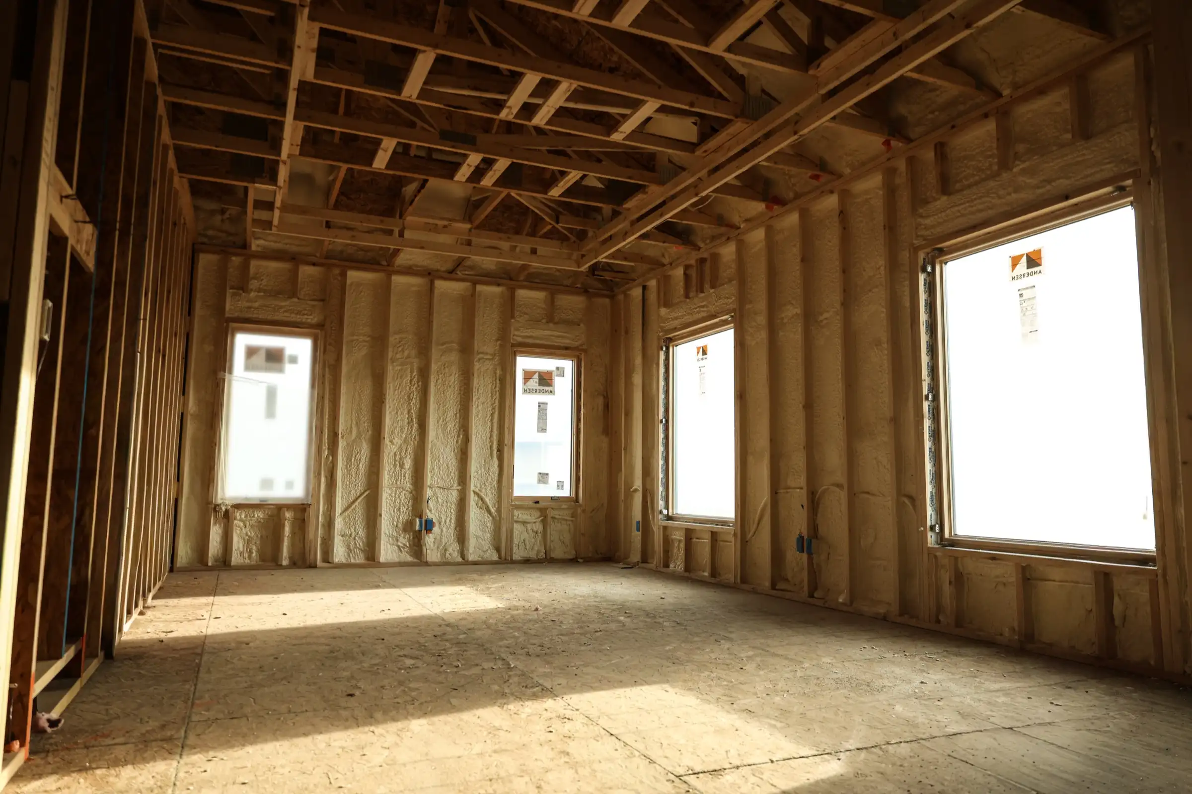 Professional installer applying spray foam insulation in a Lincoln, Nebraska building